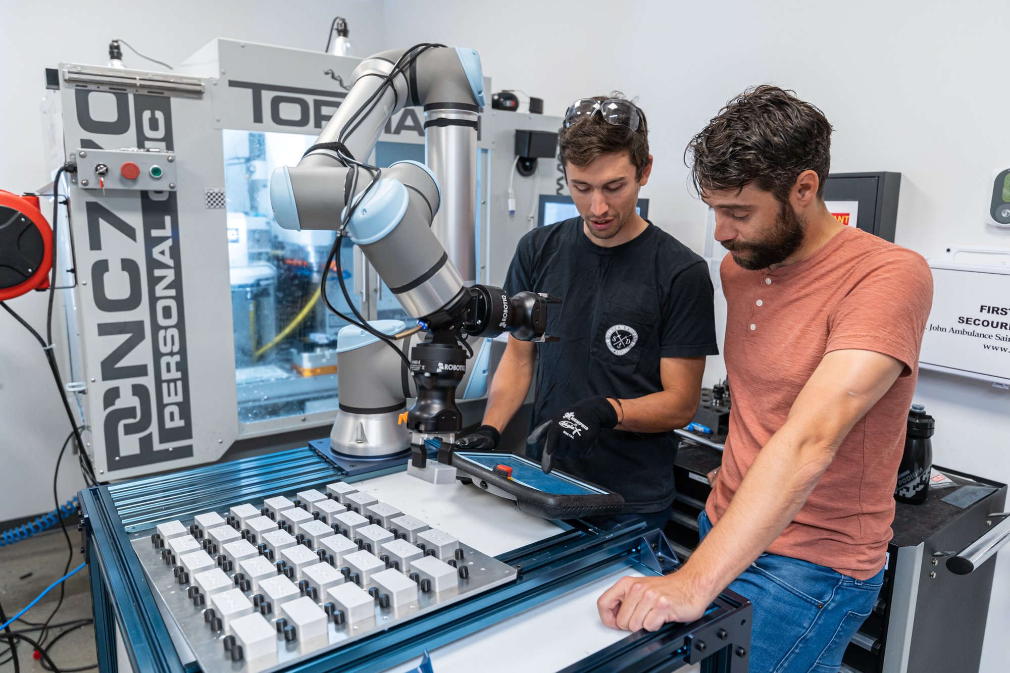 Two People in Front of Cell - CNC Machine Tending